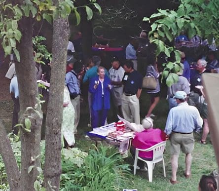 A group of people gathered in the grass.