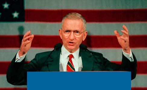 A man in a suit and tie is giving a speech.